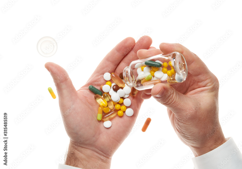 Man hand opening glass bottle full of pills, tablets, vitamins, drugs, capsules isolated on white background. White shirt, business style. Health care concept. Pharmaceutical industry. Pharmacy. Man hand opening glass bottle full of pills, tablets, vitamins, drugs, capsules isolated on white background. White shirt, business style. Health care concept. Pharmaceutical industry. Pharmacy.