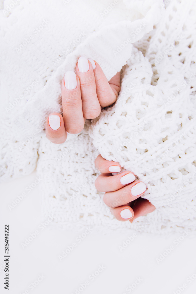 Stylish trendy white manicure. Tender female hands. Stylish trendy white manicure. Tender female hands.