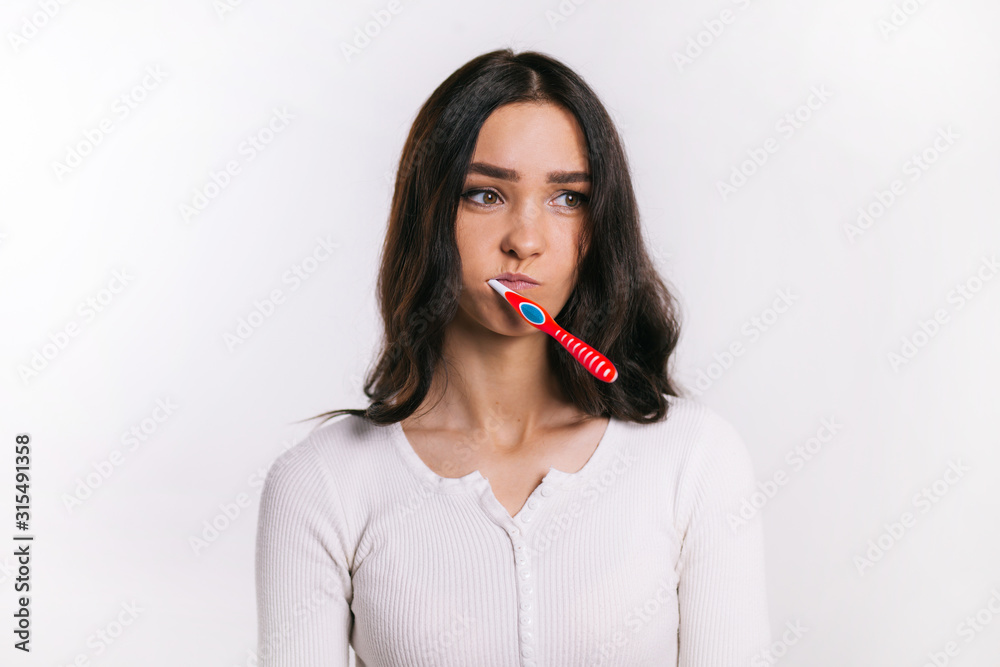 girl on a white background and a toothbrush girl on a white background and a toothbrush