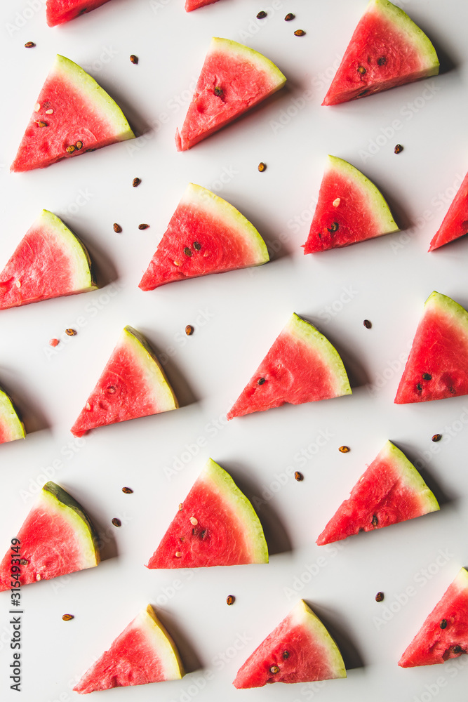 Seamless summer pattern. Watermelon slices, seeds on white background, top view Seamless summer pattern. Watermelon slices, seeds on white background, top view