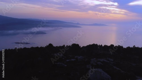 Breathtaking multicolored sunset above the sea. Mirador de Monte Branco, Ponteceso aerial ascending dolly in shot photo