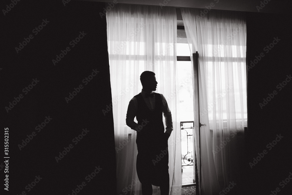 Silhouette of groom in the morning at hotel