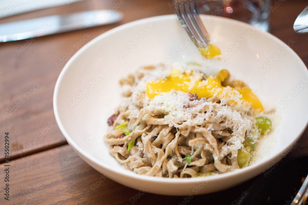 Homemade wheat fetuccini with cream sauce and egg Homemade wheat fetuccini with cream sauce and egg