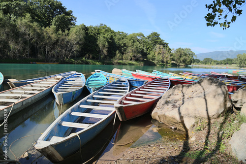 TAMUL, SAN LUIS POTOSI MEXICO - January 6, 2020:Colorful canoes on the Tamul river in Huasteca, these canoes will be used for the river tour and until you reach the waterfall photo