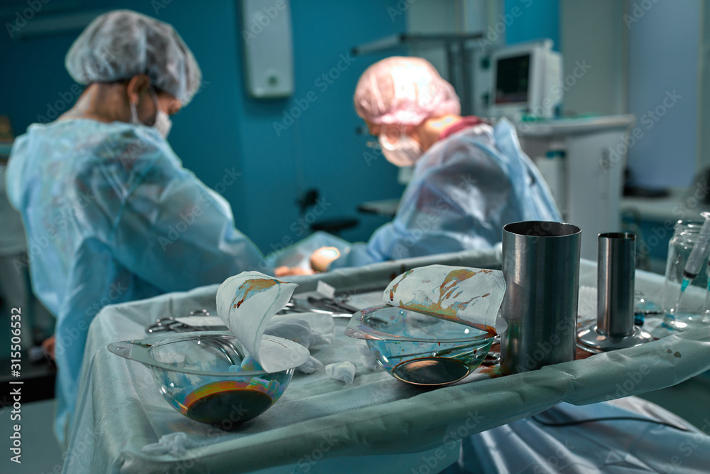 Group of surgeons in operating theater. Medical team performing surgery in operation room. Group of surgeons in operating theater. Medical team performing surgery in operation room.