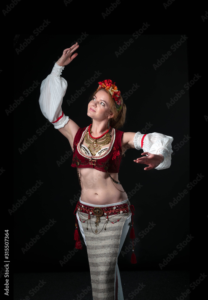 Pollerin beautiful dancer in traditional folk costume in slavic stile with ...