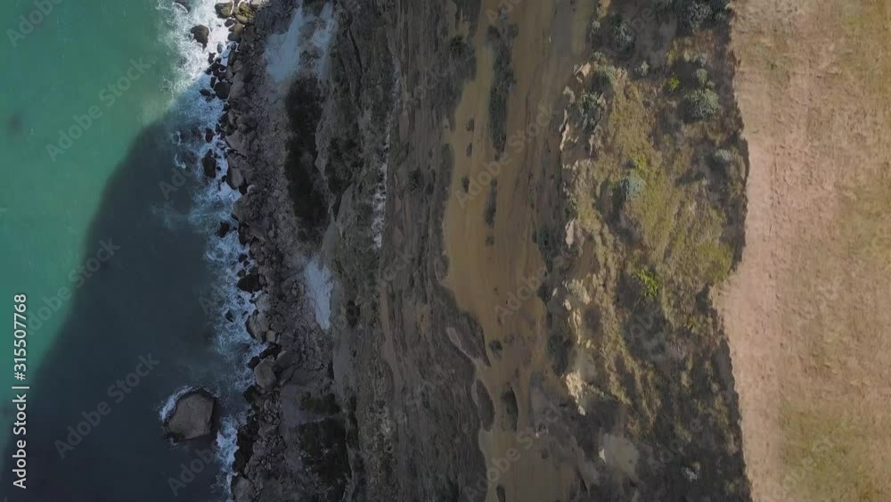 Overhead view of the Castle Rock cliff face and shore at Castlepoint, New Zealand Overhead view of the Castle Rock cliff face and shore at Castlepoint, New Zealand