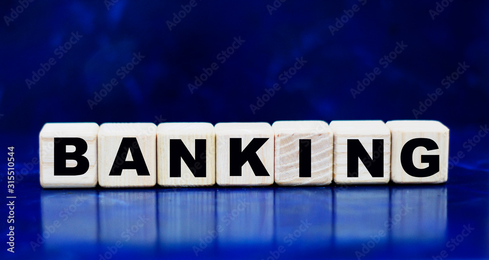concept word banking on wooden cubes on a blue background