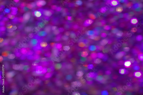 Abstract multicolored purple rainbow background. Defocused light sparkles with bokeh effect.