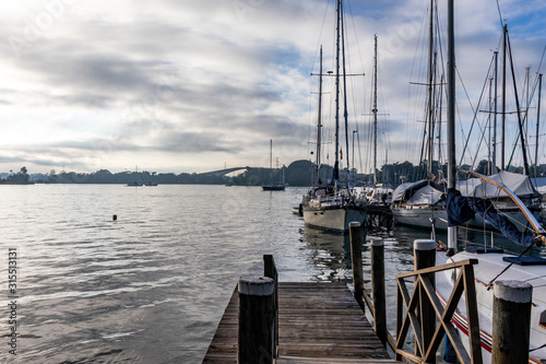 Boats and deck at the marina, Izabal Lake coast at the Caribbean sea, sky with white clouds, Sweet River, Puerto Barrios, Guatemala. tropical landscape background.