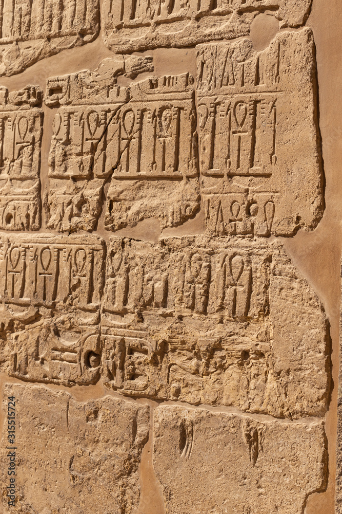 Karnak Temple, complex of Amun-Re. Embossed hieroglyphics on walls. Luxor Governorate, Egypt. Ankh is an ancient Egyptian hieroglyphic symbol that means the word 