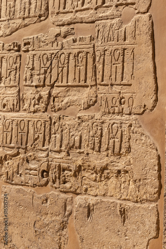 Karnak Temple, complex of Amun-Re. Embossed hieroglyphics on walls. Luxor Governorate, Egypt. Ankh is an ancient Egyptian hieroglyphic symbol that means the word "life".