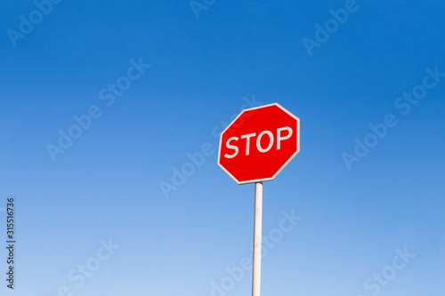 Stop sign against the blue sky.