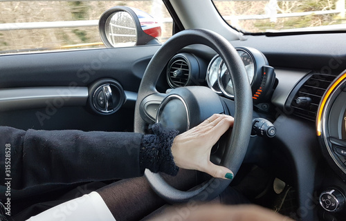 steering wheel drivers hands and modern black car