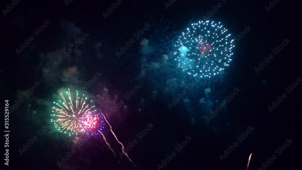 Beautiful abstract colourful Fireworks explode display on sky at night a symbol of celebration in New years anniversary for background