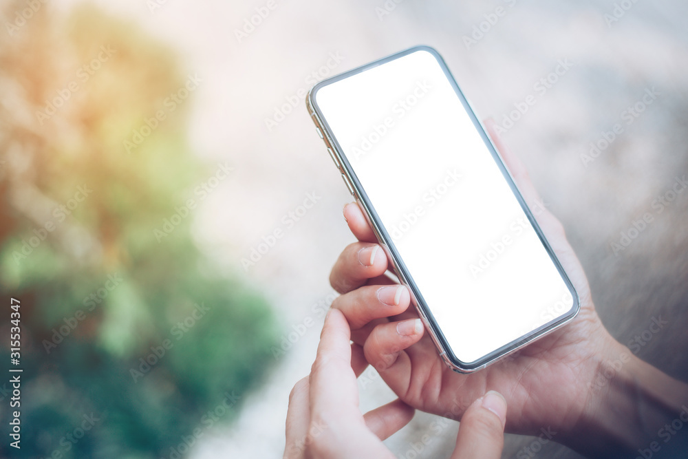 Mockup image blank white screen cell phone.woman hand holding texting using mobile.background empty space for advertise text.people contact marketing business,technology 