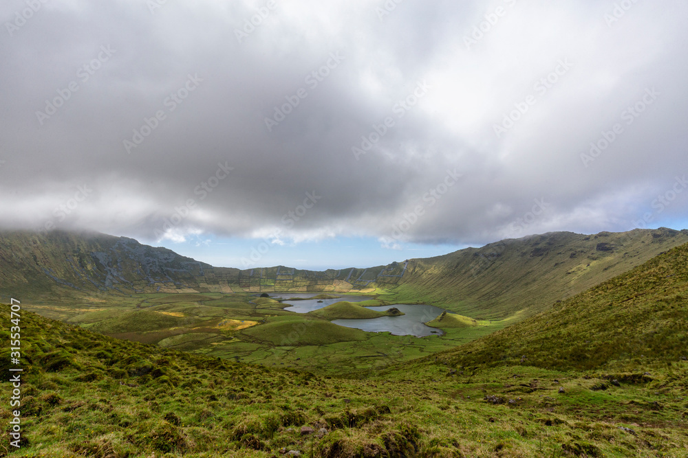 Small summer lakes in the pastures of the Corvo crater on the island of Corvo in the Azores, Portugal. Small summer lakes in the pastures of the Corvo crater on the island of Corvo in the Azores, Portugal.