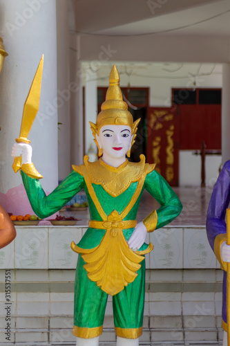 Angle statue holding arm at the temple