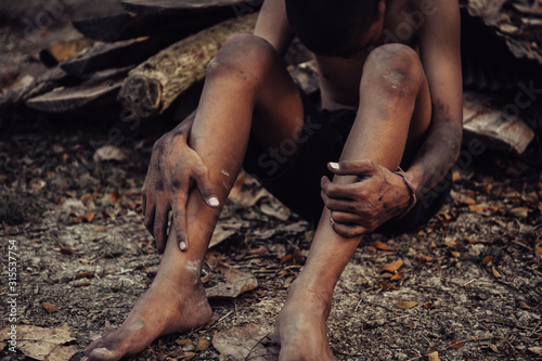 hands poor child or beggar begging you for help sitting at dirty slum. concept for poverty or hunger people,human rights,donate and charity for underprivileged children in third world 