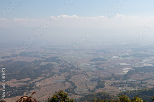 Misty landscape of rice filed under blue sky in Keng Tung, Shan State, Myanmar