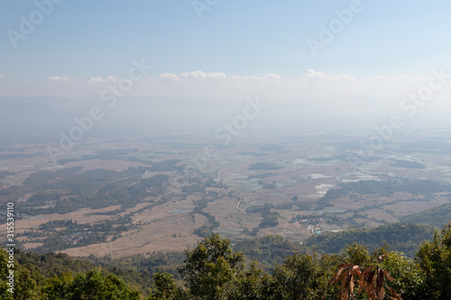 Misty landscape of rice filed under blue sky in Keng Tung, Shan State, Myanmar