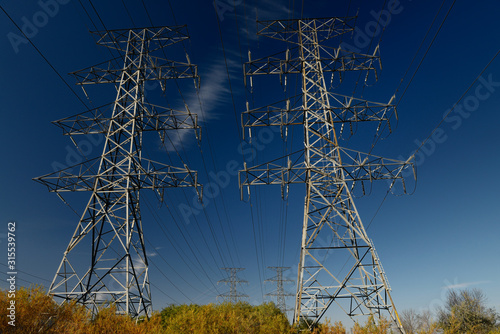 Canvas Print Hydro towers against blue sky in the Fall in Ontario