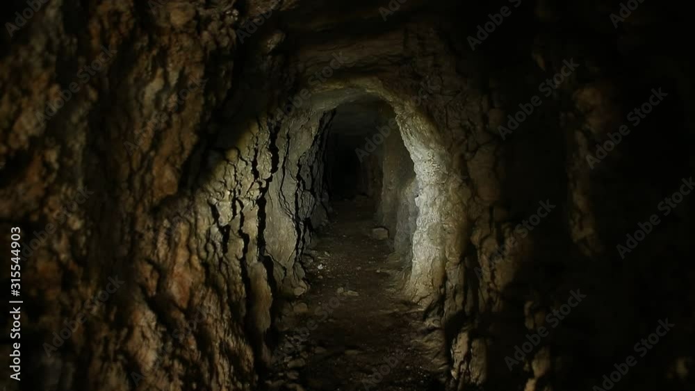 Flashlight or Torch on Walls of Abandoned Mine Tunnel Flashlight or Torch on Walls of Abandoned Mine Tunnel