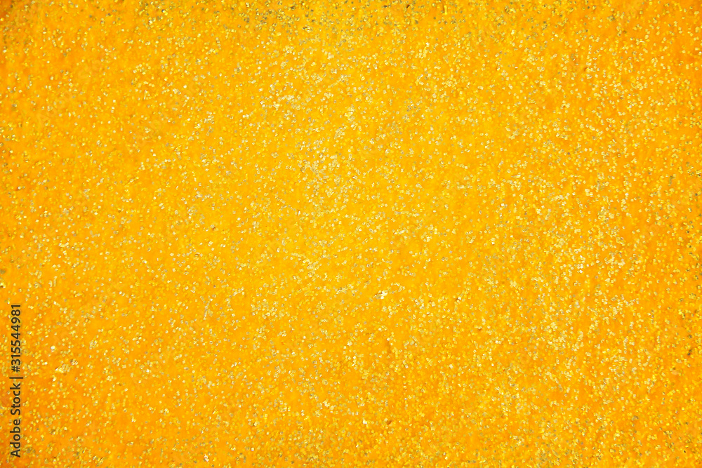 Gold sparkle glitter paint wall texture on colorful blank background Gold sparkle glitter paint wall texture on colorful blank background