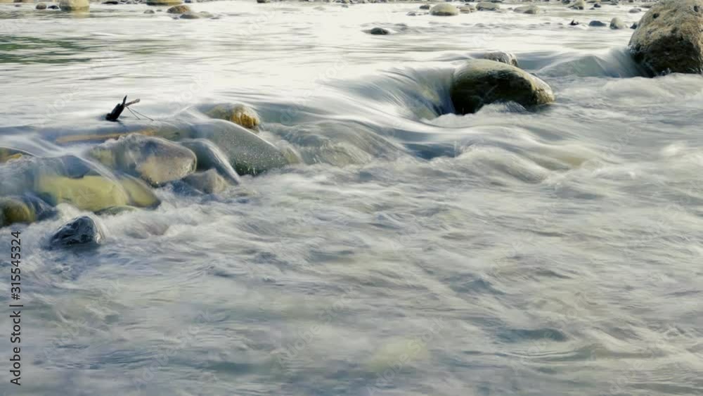 Flowing water over rapids in river shot at 1/8th shutter speed for a nice slow-mo-not slow-mo effect. Flowing water over rapids in river shot at 1/8th shutter speed for a nice slow-mo-not slow-mo effect.