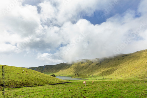 Sun peaks out into the basin of the Corvo Crater on the island of Corvo in the Azores, Portugal.