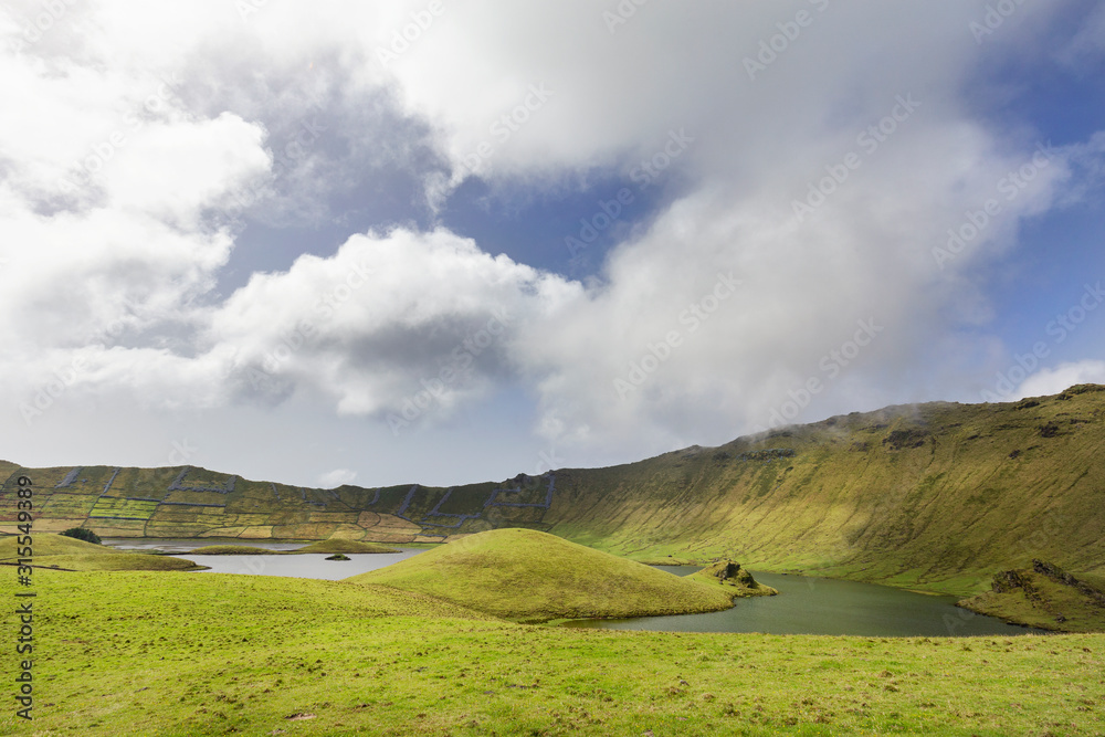 Wafting white clouds over the lakes in the Corvo caldera on the island of Corvo in the Azores, Portugal.