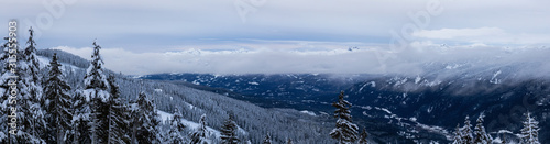 Whistler, British Columbia, Canada. Beautiful Panoramic View of the Canadian Snow Covered Mountain Landscape during a cloudy and colorful winter sunset.