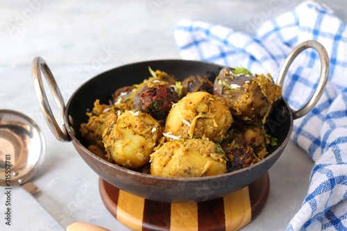 Food - Traditional Indian Gujarati dish Surti Undhiyu. Its a mixed vegetable dish cooked with stuffed brinjals, fried potatoes, Methi Muthia, purple yam, Papadi and spices. Makar Sankranti Special. photo