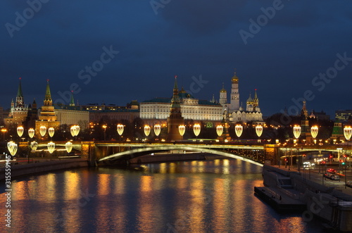 Beautiful evening view of the Moscow Kremlin and the Big Stone bridge with festive illumination. Moscow, Russia