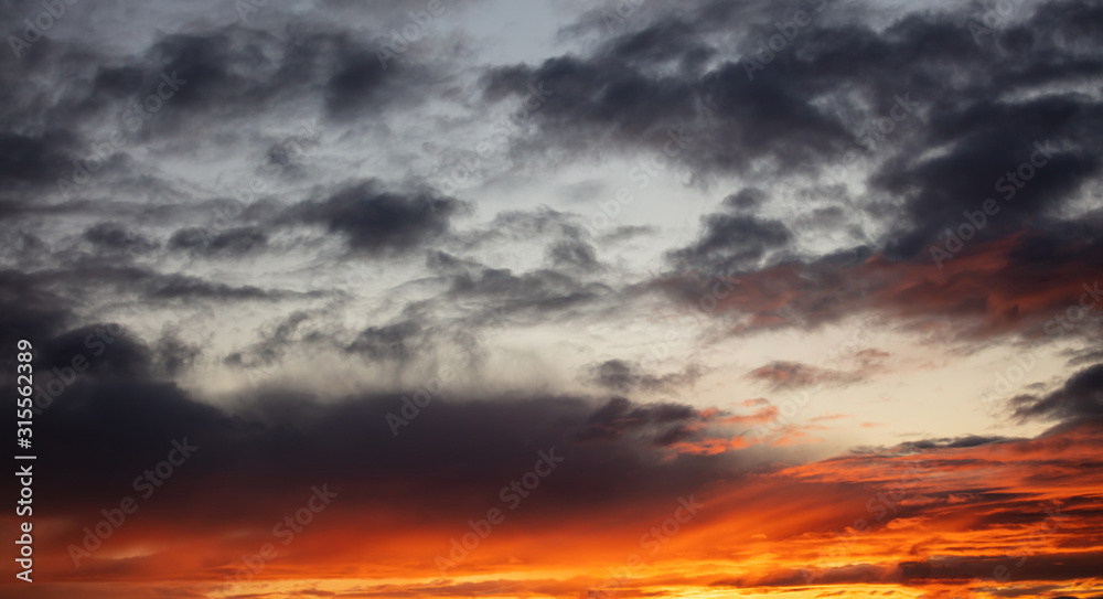 Sunrise clouds. Dramatic magical sunset over orange cloudy sky
