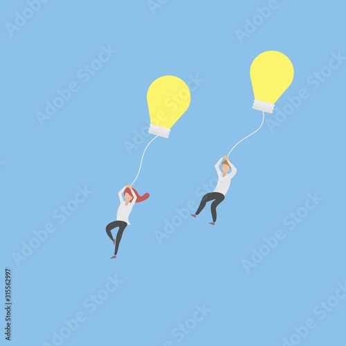Release creative idea concept,Man and women let idea go to the sky with yellow light bulb.