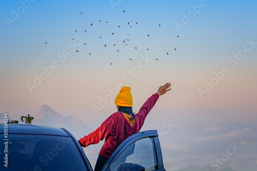 young woman enjoy the nature life of travel on the peak of mountain with cheerfully life of the nature surrounding