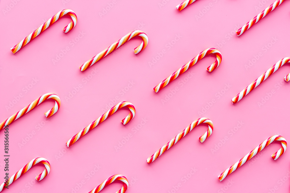 Christmas candy cane pattern on pink background top-down Christmas candy cane pattern on pink background top-down