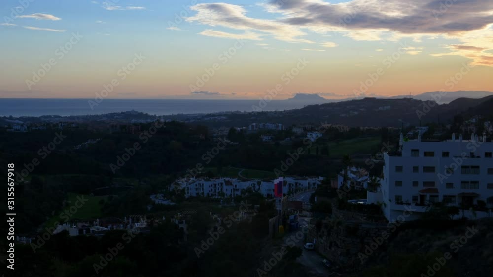 Time lapse. Sunset view to Giibraltar from Los Arqueros, Costa del Sol - Spain, with colorful clouds. Panoramic coastline view. Time lapse. Sunset view to Giibraltar from Los Arqueros, Costa del Sol - Spain, with colorful clouds. Panoramic coastline view.