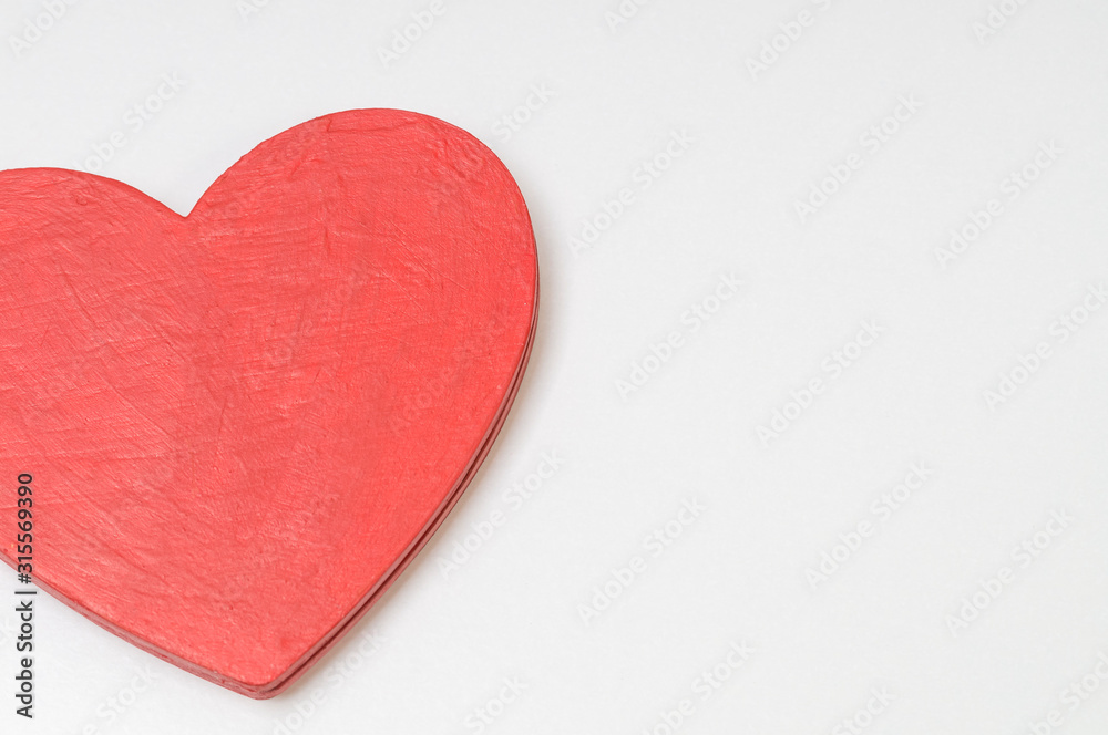 red wooden heart on a white background, wood texture, Valentine with a copy space red wooden heart on a white background, wood texture, Valentine with a copy space