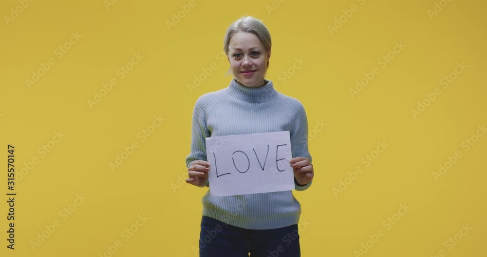 Woman holding love sign Woman holding love sign