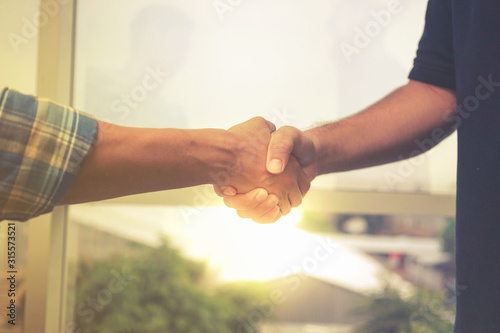 Handshake. Busniess men are shaking hand with each other for doing some power agreement. Trust and holding hand.