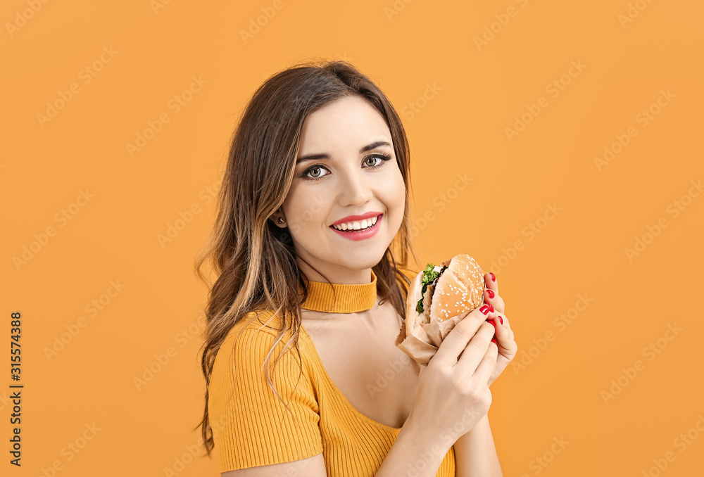 Portrait of beautiful young woman with burger on color background Portrait of beautiful young woman with burger on color background
