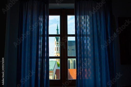 Defocused image of the facade of St. Vitus Church through a window from inside of a house in Cesky Krumlov  Czech Republic