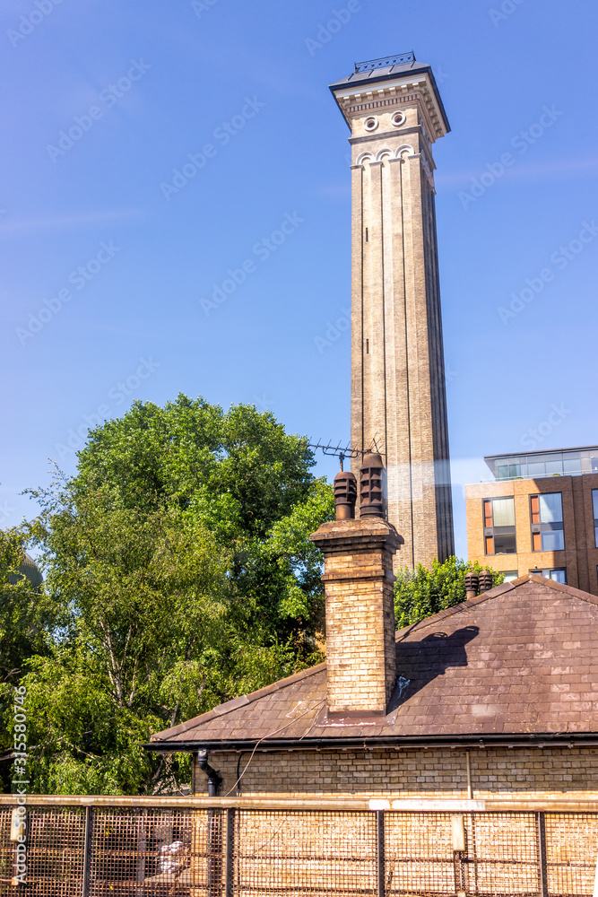 London, UK Industrial railroad transport in United Kingdom, Pimlico neighborhood district Victoria station with tower and house chimney on roof