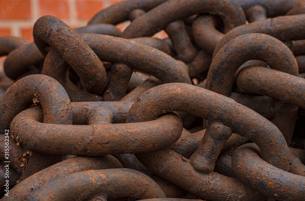 Rusty anchor chain close-up on a brick wall background Rusty anchor chain close-up on a brick wall background