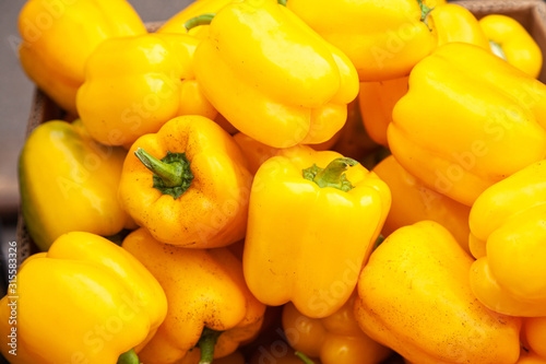 Fresh yellow pepper lying on the market counter. Yellow pepper texture, bright healthy vegetables and vegetatarian texture of yellow peppers photo