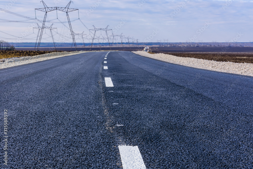 Fototapeta premium New asphalt road with the white dividing strip