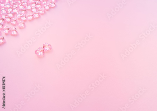 Elegant composition for Valentine's Day.Elements in shape of heart flying on pastel pink background.Symbols of love for Happy Women's, Mother's, Valentine's Day. Flat lay, top view, copy space, banner © Ольга Остапенко