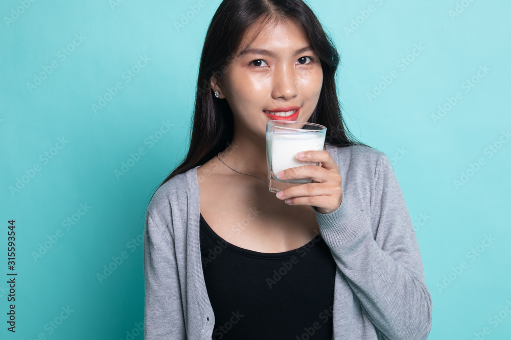 Healthy Asian woman drinking a glass of milk. Healthy Asian woman drinking a glass of milk.